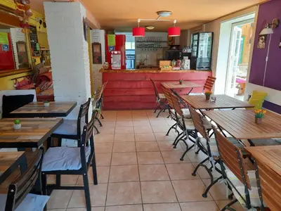 a row of tables and chairs in a restaurant at Lodge Safari tent in Camurac