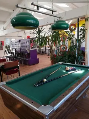 a pool table with a cue on top of it at Loft au piémont des Pyrénées Cathares in Sainte-Colombe-sur-lʼHers