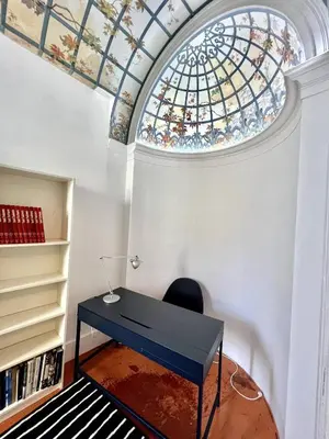 a desk in a room with a stained glass ceiling at SUNNY , terrasse, climatisation, centre ville in Carcassonne