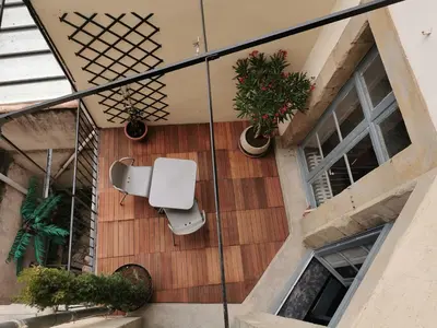 an external view of a balcony with plants and a toilet at SUNNY , terrasse, climatisation, centre ville in Carcassonne