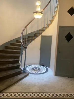 a spiral staircase in a house with a door at SUNNY , terrasse, climatisation, centre ville in Carcassonne