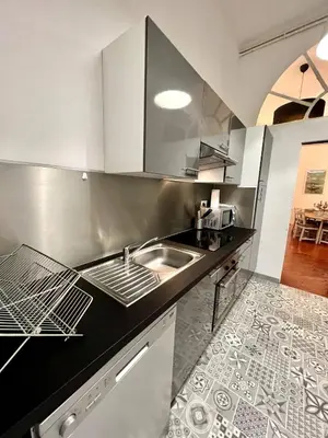 a kitchen with a sink and a counter top at SUNNY , terrasse, climatisation, centre ville in Carcassonne