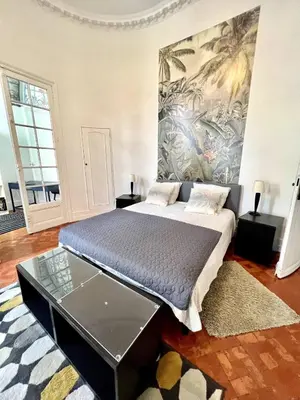 a bedroom with a bed with a mural on the wall at SUNNY , terrasse, climatisation, centre ville in Carcassonne