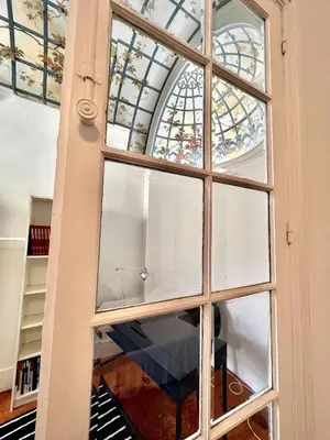 a large window in a building with a stained glass ceiling at SUNNY , terrasse, climatisation, centre ville in Carcassonne