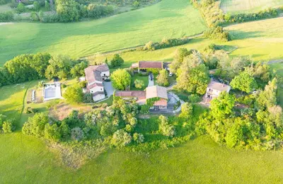 an aerial view of a large house in a field at La Bastide in Puycalvel Lautrec