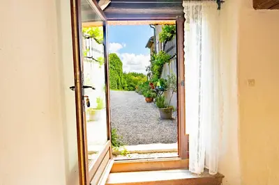 an open window with a view of a street at La Bastide in Puycalvel Lautrec