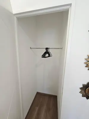 a hallway with a closet with a light on the wall at Tout confort ! Ville, Climatisation, Parking, Wifi, Calme, TV in Carcassonne