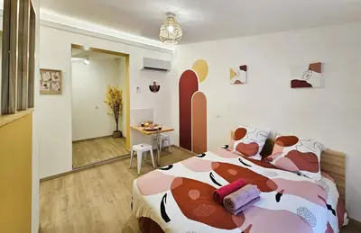 a bedroom with a bed with a cow patterned blanket at Tout confort ! Centre-ville, Climatisation, Parking, Wifi, Calme, TV in Carcassonne