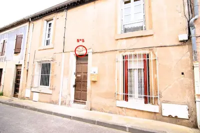 a building with a clock on the side of it at Tout confort ! Centre-ville, Climatisation, Parking, Wifi, Calme, TV in Carcassonne