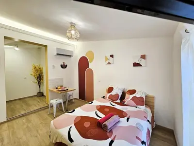 a bedroom with a bed and a desk in a room at Tout confort ! Centre-ville, Climatisation, Parking, Wifi, Calme, TV in Carcassonne