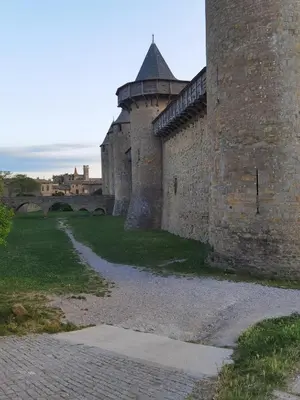 an old castle with a brick wall and a street at Cyprès de vos rêves in Ornaisons