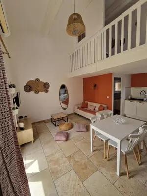 a living room with a table and a couch at Cyprès de vos rêves in Ornaisons