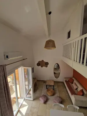 a living room with a staircase and a couch at Cyprès de vos rêves in Ornaisons