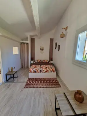 a bedroom with a bed in the middle of a room at Cyprès de vos rêves in Ornaisons