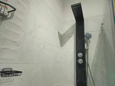 a shower with a black shower head in a bathroom at AV de Bordeaux in Narbonne