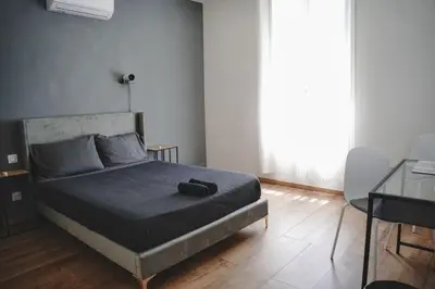 a bedroom with a bed with a black bag on it at AV de Bordeaux in Narbonne