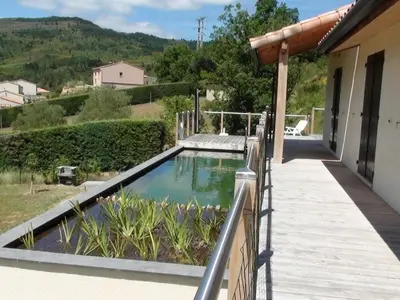 a swimming pool on a porch with a house at Maison Des Levriers met zwemvijver en airco in Katharenland in Luc-sur-Aude