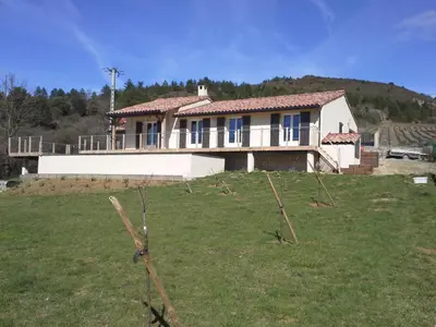 a house sitting on top of a grassy hill at Maison Des Levriers met zwemvijver en airco in Katharenland in Luc-sur-Aude