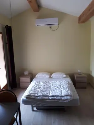 a bedroom with a bed in a room at Maison Des Levriers met zwemvijver en airco in Katharenland in Luc-sur-Aude