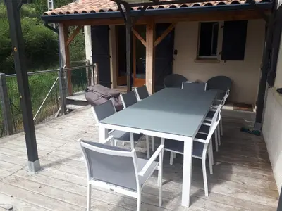 a white table and chairs on a deck at Maison Des Levriers met zwemvijver en airco in Katharenland in Luc-sur-Aude