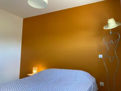 a bedroom with a bed and a hat on a wall at Stylish Villa in Sainte-Valière in Sainte-Vallière