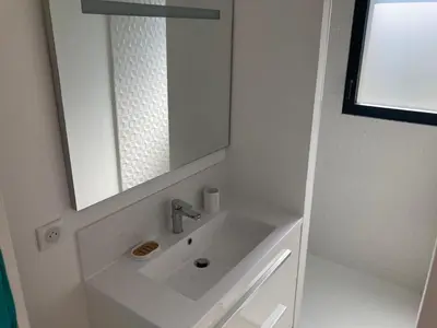 a white bathroom with a sink and a mirror at Stylish Villa in Sainte-Valière in Sainte-Vallière