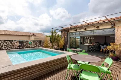 a patio with a swimming pool and a table and chairs at Le Couvent des Ursulines - Penthouse climatisé piscine in Narbonne