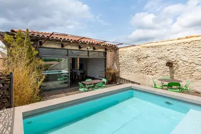 a swimming pool in the backyard of a house at Le Couvent des Ursulines - Penthouse climatisé piscine in Narbonne