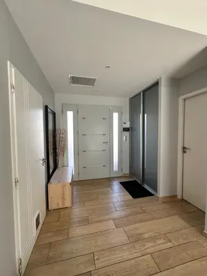 an empty room with a hallway with a wooden floor at Maison paisible toute équipée, piscine chauffée in Sallèles-dʼAude