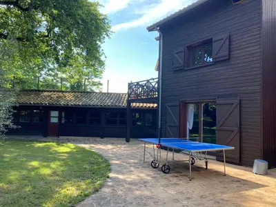 a blue ping pong table in front of a house at Maison exceptionnelle piscine in Aussillon