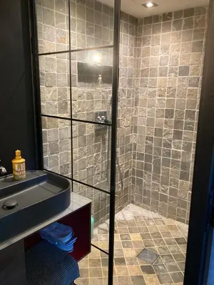 a bathroom with a shower and a sink at Maison exceptionnelle piscine in Aussillon