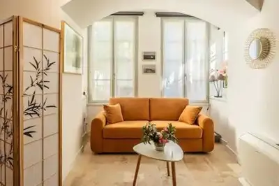 a living room with a couch and a table at Le clos des jacobins in Narbonne