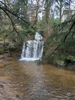 a waterfall in the middle of a river at Mobilhome Les volets bleus in Vaudreuille