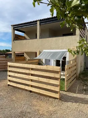 a wooden fence in front of a house at Studio à l'Ecurie in Narbonne