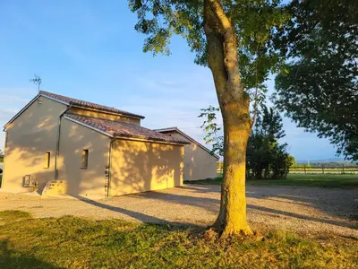 a small white building with a tree next to it at Chambre Le Ka-Marrant in Les Pujols