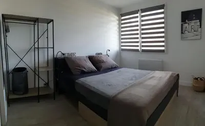 a bedroom with a bed and a window at Le Loft in Caraman