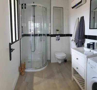 a bathroom with a shower and a toilet and a sink at Le Loft in Caraman