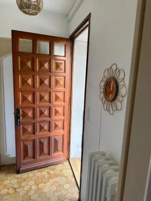 a wooden door in a room with at Maison proche de la Cité avec jardin in Carcassonne
