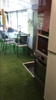 a kitchen and dining room with a table and chairs at Bus atypique au bord du canal du midi et au cœur d'une forêt 2 chambres in Villepinte