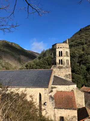 an old stone church with a tower in the mountains at Havre de paix in Mas-Cabardès