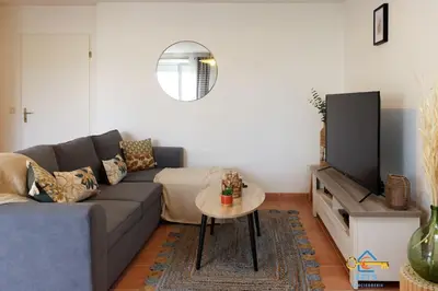 a living room with a couch and a table at Superbe Nid Douillet avec Terrasse, Double Parking in Carcassonne