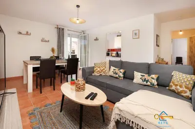a living room with a couch and a table at Superbe Nid Douillet avec Terrasse, Double Parking in Carcassonne