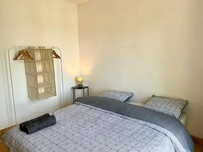 a bedroom with a bed with a blue comforter at Villa Louis - calme et spacieuse avec vue in Castelnaudary