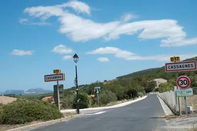an empty road with signs on the side of the road at Charmante Maison de Village dans les fenouilledes in Cassagnes