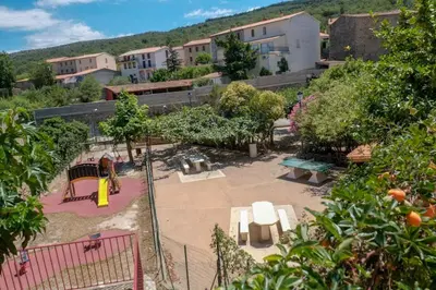 a park with a playground with tables and benches at Charmante Maison de Village dans les fenouilledes in Cassagnes