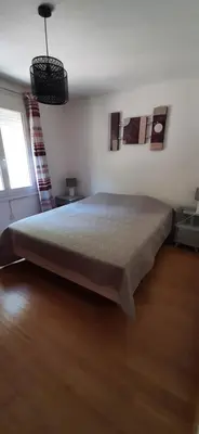 a bedroom with a large bed and a window at Villa Bellevue in Roquefort-des-Corbières