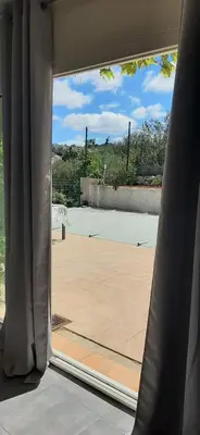 a view of a tennis court through a window at Villa Bellevue in Roquefort-des-Corbières