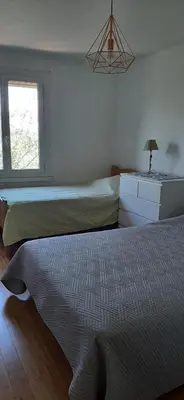 a bedroom with two beds and a window at Villa Bellevue in Roquefort-des-Corbières