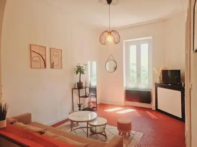 a living room with a couch and a table at Appartement Centre Ville Les Halles - Grands Buffets in Narbonne