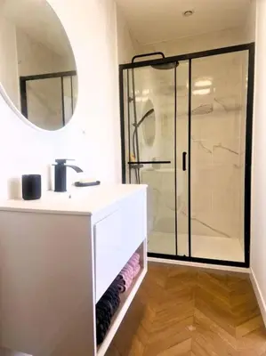 a bathroom with a white sink and a shower at Appartement Centre Ville Les Halles - Grands Buffets in Narbonne